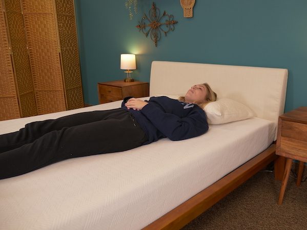 Julia Forbes testing a mattress for back sleeping